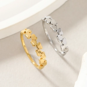 Close-up of wavy gold and silver minimalist rings with polished finish details