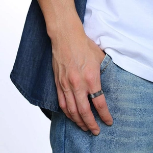 Close-up of minimalist dark grey matte metal ring worn as a casual everyday accessory