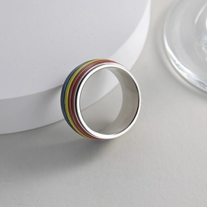 Polished silver stainless steel spinner ring with colorful rainbow enamel stripes
