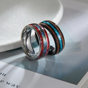 Unique stainless steel rings with red shell and blue stone inlays on white display