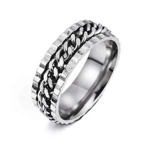 Macro shot of silver spinner ring with rotatable cuban chain and punk gear edges