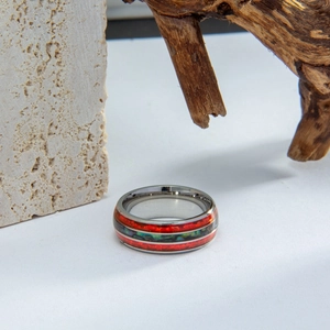 Macro shot of polished ring featuring vibrant opal shell inlays on wooden background