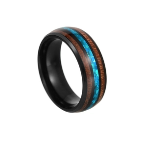 Minimalist wood inlay ring with turquoise stones and black metal band on white background