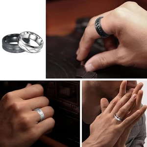 Detail of men's black matte and silver leaf pattern rings with chain link decoration