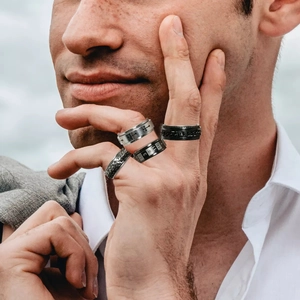 Set of four rotating stainless steel rings for men featuring black Cuban chain and cross designs
