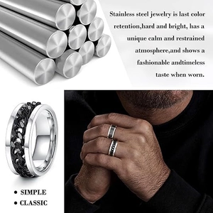 Detail of men's stainless steel spinner ring with a black Cuban chain inlay design