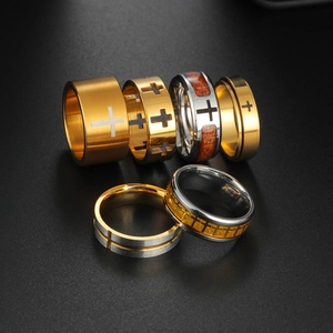 Detailed close-up of six titanium cross rings with gold, silver and wood grain finishes