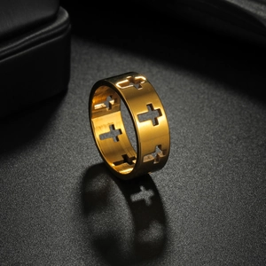 Exotic golden cutout cross ring in titanium steel on a textured dark background