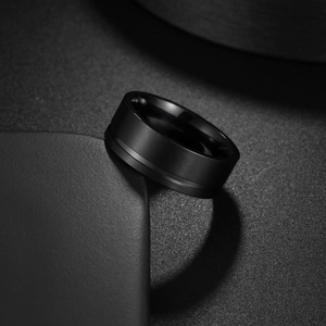 Men's matte black titanium steel wedding band with brushed finish and center groove line
