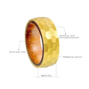 Detail view of 8mm titanium steel ring with hammered texture and pear wood inlay