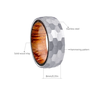 Detail of 8mm titanium steel ring featuring hammered texture and solid wood inlay