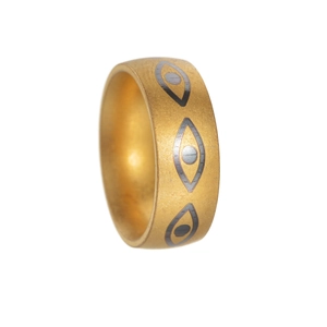 Golden brushed stainless steel ring with evil eye patterns in a vintage ethnic style