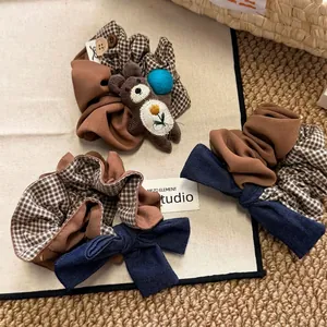 Three Korean-style hair scrunchies featuring brown teddy bear decor and checkered patterns