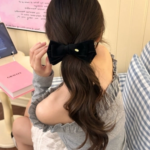 Elegant large black velvet bow banana clip for ponytail styling on a person