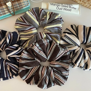 Set of four vintage striped knit scrunchies in assorted colors for retro hairstyles