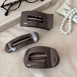 French vintage dark brown marble texture hair clips set on elegant background