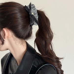 Elegant leopard print bow banana hair clip for high ponytail styling on dark brown hair