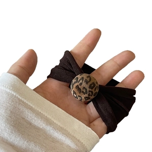 Elastic leopard print hair tie for women featuring a stylish round patterned charm