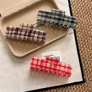 Three-piece checkered acetate hair claw clips in black, brown and red patterns