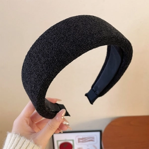 Detail of black thick knitted sponge headband with textured fabric and soft lining