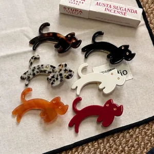 Barrettes à cheveux chat mignonnes en acétate en six couleurs sur tissu beige