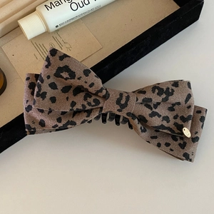 French vintage leopard print bow banana clip with elegant matte fabric and gold medal detail