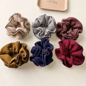 Set of 6 knit scrunchies in diverse colors with contrast wavy stitching details