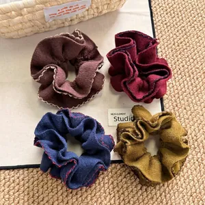 Retro knit scrunchies set in earthy tones with wavy contrast stitching for bun hairstyles