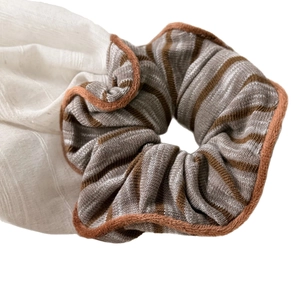 Retro striped knit scrunchie in brown and beige with soft plush edges for ponytails
