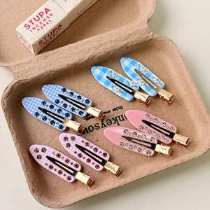 Vintage floral rhinestone hair clips set with blue and pink patterns in a gift box