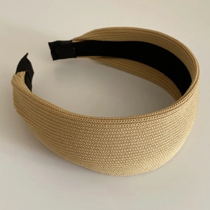 Detail shot of the khaki woven texture and non-slip lining on this wide headband