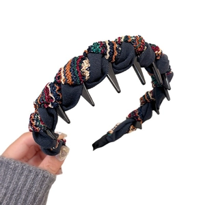 Retro deep blue knit headband with colorful jacquard weave and edgy black plastic spikes
