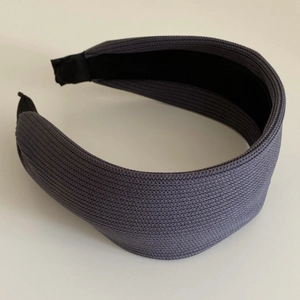 Detailed view of the dark grey knitted headband showing high-quality woven fabric texture