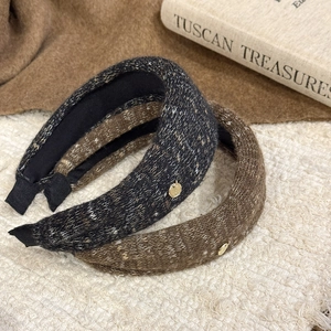 Plush padded knit headbands in dark grey and coffee brown with gold logo metal charms