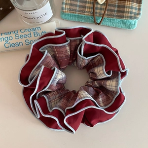 Close-up of vintage wine red and plaid scrunchie with light blue piping detail