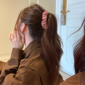 Elegant pink velvet ruched banana hair clip with golden butterfly detail on ponytail