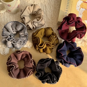 Set of 7 colorful knitted scrunchies with wavy edge stitching for hair styling