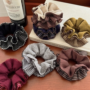 Chic striped knit scrunchies set in various colors on an elegant wooden background