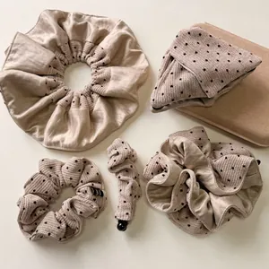 Polka dot silk hair scrunchie set and matching storage pouch in apricot cream finish