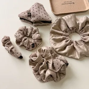 Chic beige polka dot hair accessories set including hair claw and scrunchies