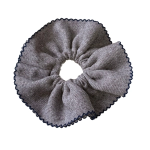 Oversized gray knit scrunchie with blue scalloped edges for elegant ponytail styling