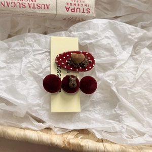 Close-up of vintage red polka dot clip and velvet beads with cute puppy charms