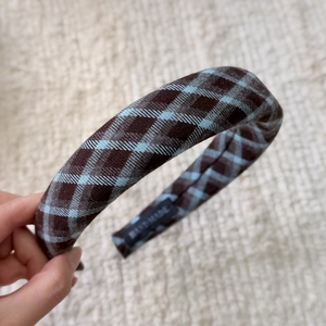 Close-up of vintage blue and brown checkered sponge headband with HANDMADE label