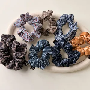 Gros plan de chouchous vintage à carreaux et fleurs avec étiquettes fait main sur un plateau