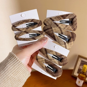 Set of 6 brown plaid fabric hair clips for women on a white display card with home decor