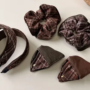 Brown leather and checkered hair accessory set with headband, scrunchies, and clips