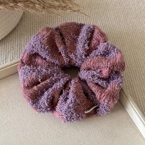 Knitted chunky scrunchie in purple and brick red yarn with soft woven texture