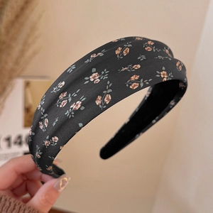 Detailed close-up showing the fabric texture and vintage floral pattern on wide headband