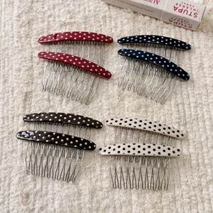 Retro polka dot hair side combs in four colors on a textured white fabric background