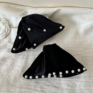 French vintage black velvet hair claw with white pearls on elegant white fabric